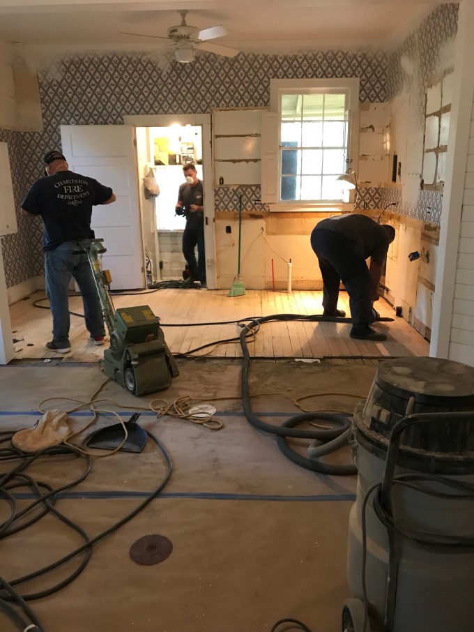 The guys working hard on the floors. 